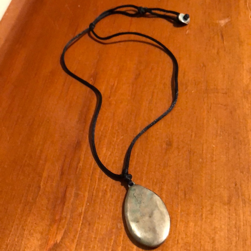 Silver pendant on adjustable string